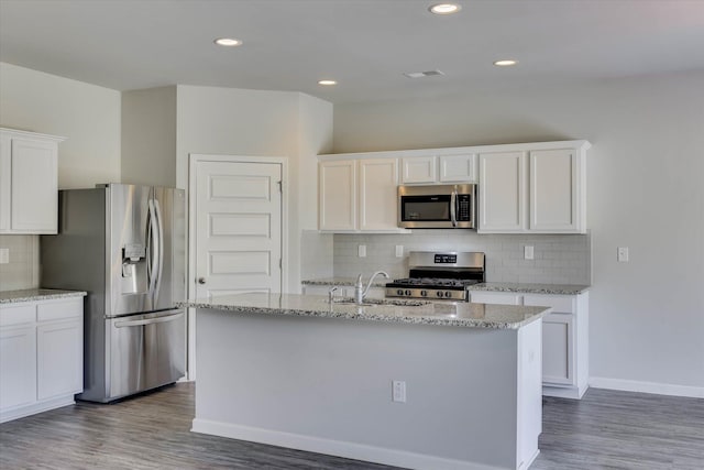 1052 Dietrich Ln, North Augusta, SC 29860 - kitchen featuring appliances with stainless steel finishes, backsplash, white cabinetry, light stone counters, and recessed lighting