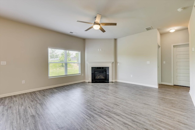 1052 Dietrich Ln, North Augusta, SC 29860 - unfurnished living room with a ceiling fan, wood finished floors, and a fireplace with flush hearth