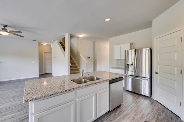 1052 Dietrich Ln, North Augusta, SC 29860 - kitchen with appliances with stainless steel finishes, white cabinets, light wood-type flooring, light stone countertops, and ceiling fan