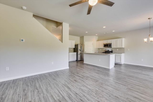 1052 Dietrich Ln, North Augusta, SC 29860 - unfurnished living room with wood finished floors, ceiling fan, recessed lighting, and a chandelier