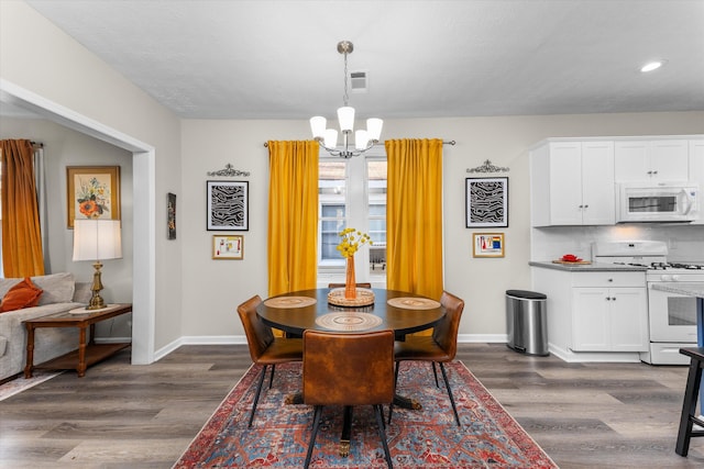dining room with visible vents, baseboards, dark wood-style floors, recessed lighting, and a notable chandelier