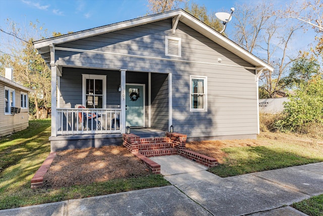 view of front facade featuring covered porch and a front lawn