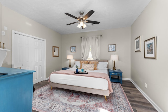 bedroom featuring baseboards, ceiling fan, a closet, and dark wood-style floors