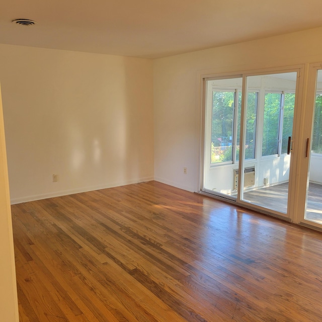 2514 Cascade Dr, Augusta, GA 30904 - spare room featuring wood finished floors, baseboards, and a wall mounted air conditioner