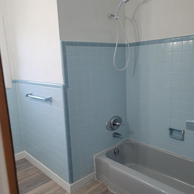 2514 Cascade Dr, Augusta, GA 30904 - bathroom featuring wood finished floors, tub / shower combination, tile walls, and a wainscoted wall