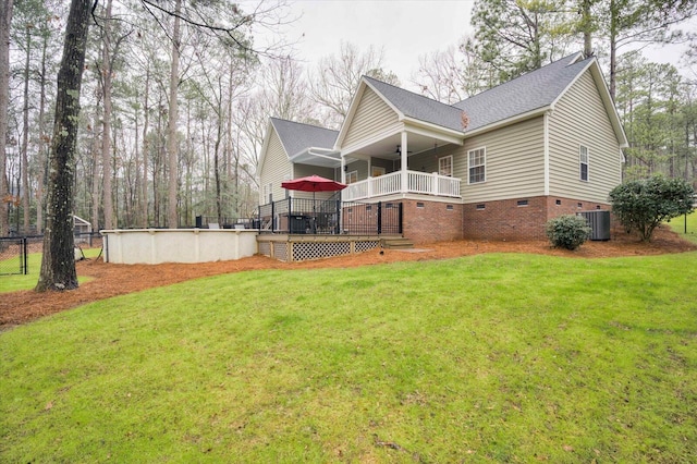 exterior space featuring a swimming pool side deck, central air condition unit, and a lawn