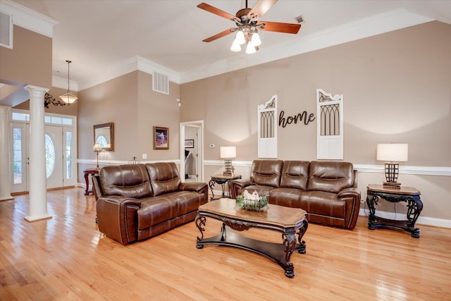 living room with ornamental molding, light wood-type flooring, and ornate columns