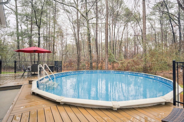 view of swimming pool featuring a deck