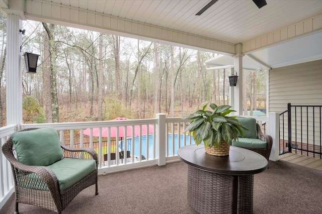 sunroom / solarium featuring plenty of natural light and ceiling fan