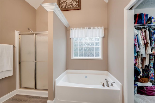 bathroom featuring shower with separate bathtub and hardwood / wood-style floors