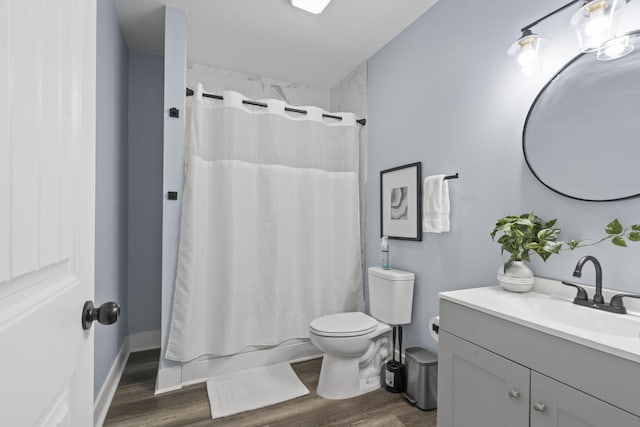 1118 Dantignac St, Augusta, GA 30901 - bathroom with wood finished floors, toilet, vanity, and shower / bath combination with curtain