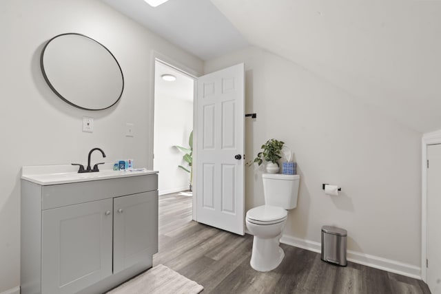 1118 Dantignac St, Augusta, GA 30901 - bathroom with toilet, wood finished floors, lofted ceiling, vanity, and baseboards
