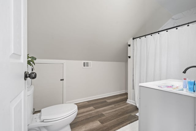 1118 Dantignac St, Augusta, GA 30901 - full bathroom featuring vaulted ceiling, wood finished floors, toilet, a sink, and baseboards