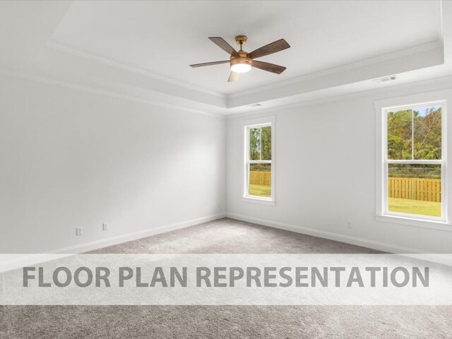 spare room featuring a tray ceiling, ceiling fan, light colored carpet, and ornamental molding