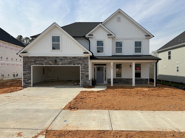 craftsman house with a porch, a garage, and a front yard