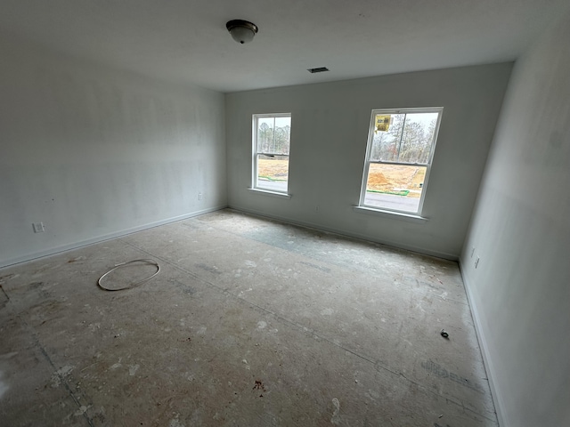 spare room featuring visible vents and baseboards