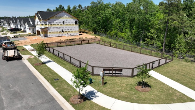 view of community with a lawn and fence