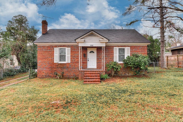 bungalow-style home with a front yard