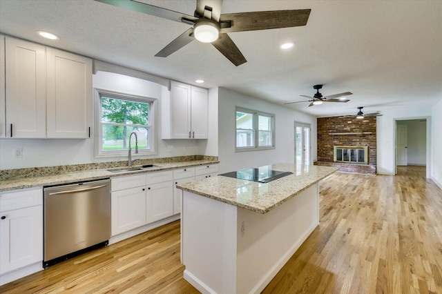 kitchen featuring white cabinets, dishwasher, light wood-type flooring, and sink