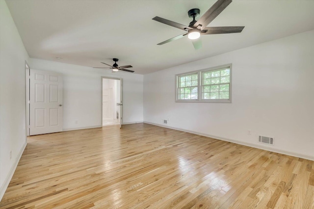 empty room with ceiling fan and light hardwood / wood-style flooring