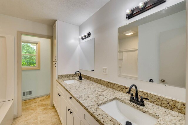 bathroom featuring vanity and a textured ceiling