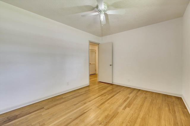 unfurnished room with ceiling fan, a textured ceiling, and light hardwood / wood-style flooring