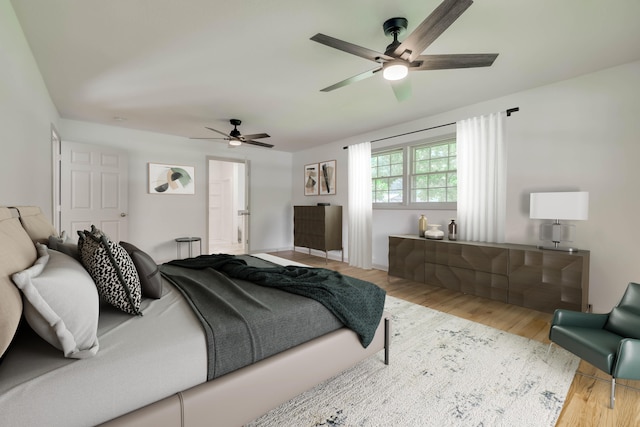 bedroom with ceiling fan and light hardwood / wood-style floors