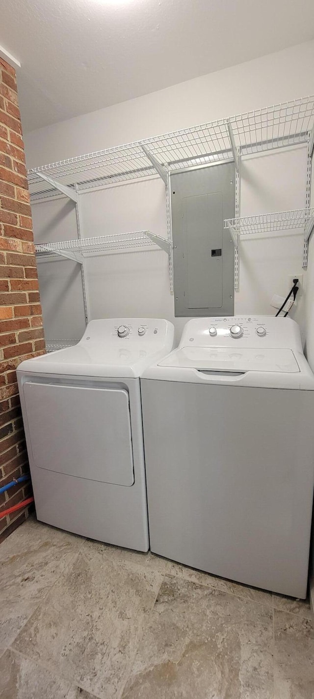 laundry area with washer and dryer and electric panel