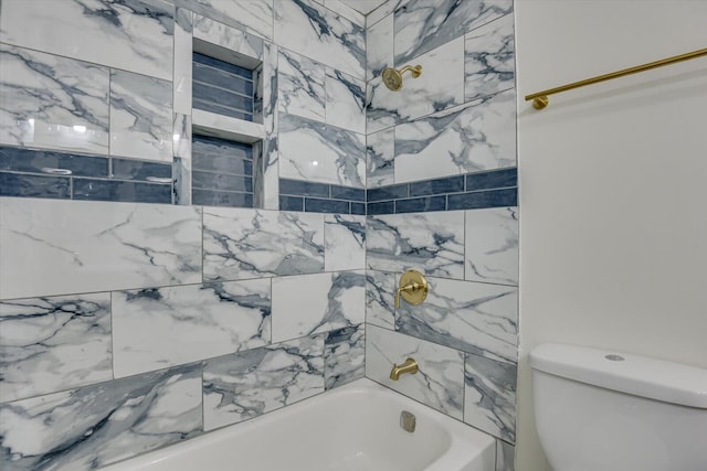 bathroom with tiled shower / bath and toilet