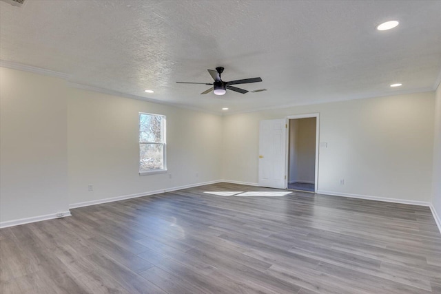 spare room with ceiling fan, crown molding, a textured ceiling, and light wood-type flooring