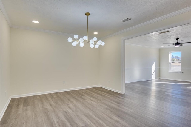 unfurnished room featuring ceiling fan with notable chandelier, ornamental molding, hardwood / wood-style floors, and a textured ceiling