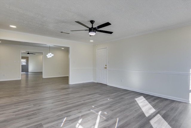 spare room with a textured ceiling, wood-type flooring, and ceiling fan