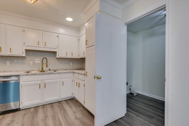 kitchen featuring white cabinetry, sink, and stainless steel dishwasher