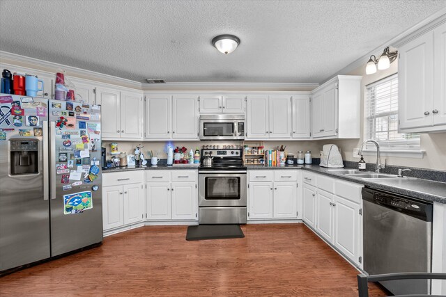 762 Winding Creek Ct, Evans, GA 30809 - kitchen with stainless steel appliances, white cabinets, and dark countertops