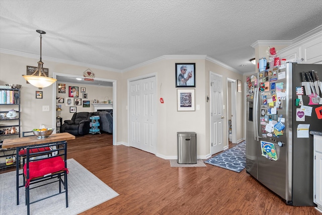 762 Winding Creek Ct, Evans, GA 30809 - dining area with wood finished floors, crown molding, a textured ceiling, and baseboards