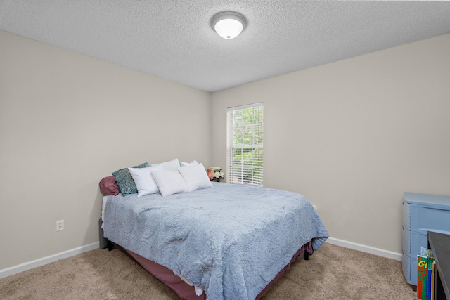762 Winding Creek Ct, Evans, GA 30809 - carpeted bedroom featuring baseboards and a textured ceiling