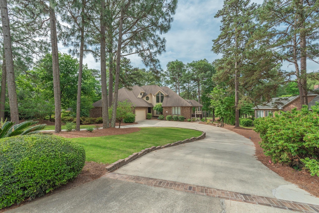 view of front facade with a garage and a front lawn