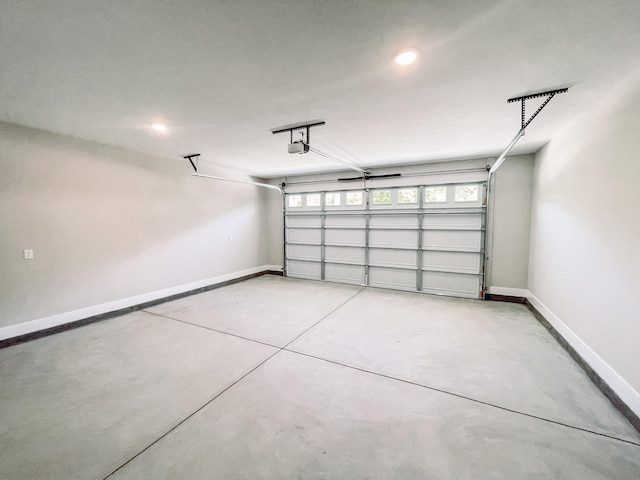 garage featuring baseboards, recessed lighting, and a garage door opener