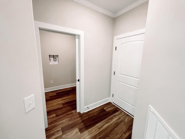 hallway with visible vents, baseboards, dark wood-style flooring, and crown molding