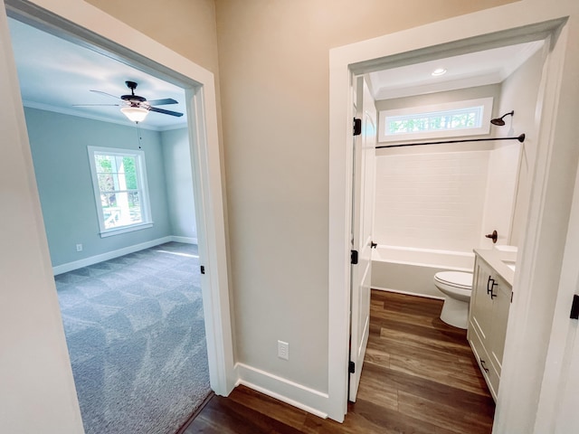 full bath featuring toilet, baseboards, wood finished floors, and crown molding