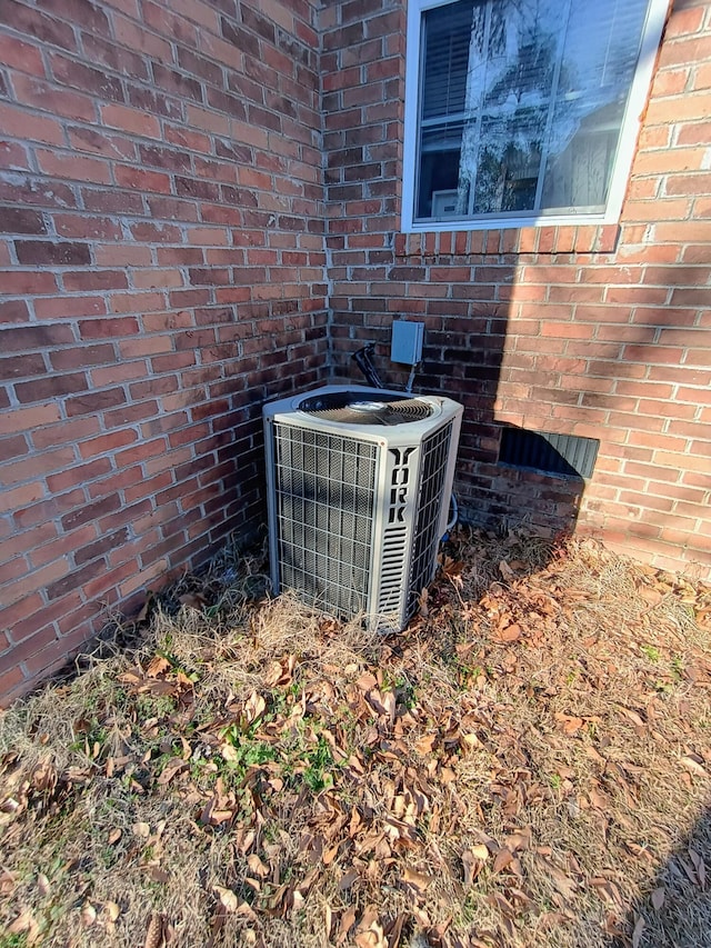 exterior details with brick siding and central AC