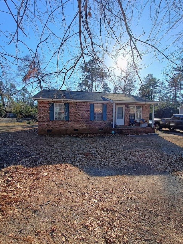 ranch-style house featuring brick siding and crawl space