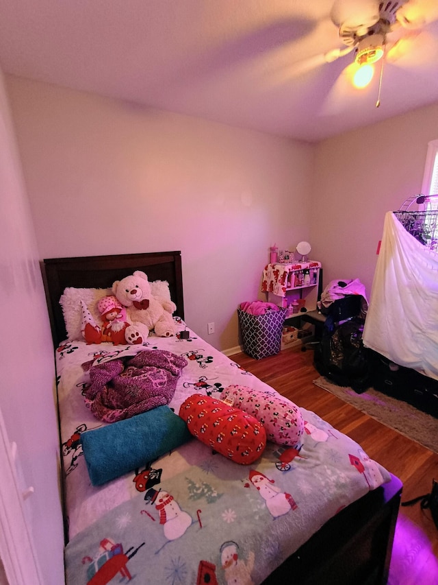 bedroom with ceiling fan and wood finished floors