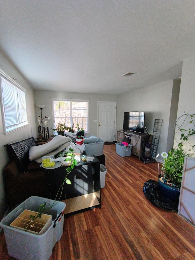 living room featuring visible vents and wood finished floors