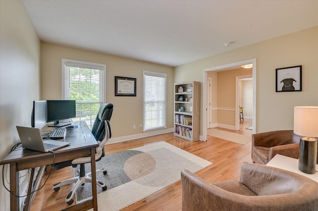 home office featuring light wood-style floors and baseboards