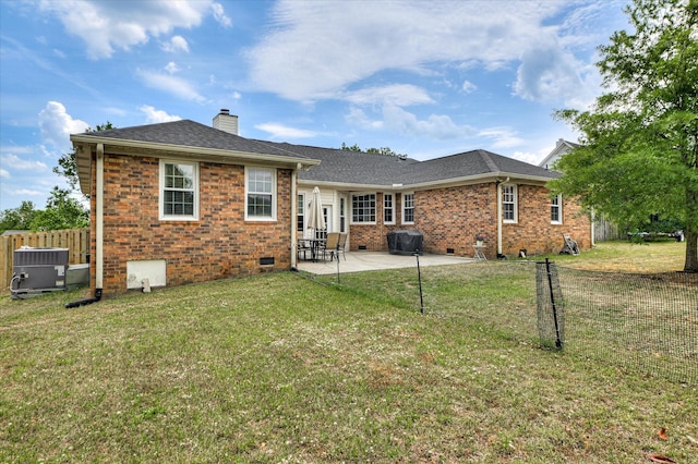 back of house with crawl space, a chimney, fence, a yard, and a patio