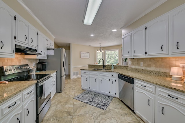 kitchen featuring appliances with stainless steel finishes, a sink, a peninsula, under cabinet range hood, and visible vents