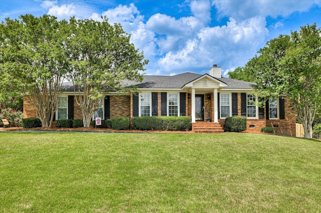 ranch-style home with crawl space, a chimney, roof with shingles, brick siding, and a front lawn