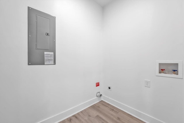 1017 Miller St, Augusta, GA 30901 - laundry area featuring electric panel, electric dryer hookup, washer hookup, light wood-style flooring, and baseboards