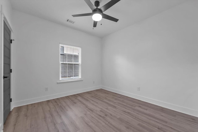 1017 Miller St, Augusta, GA 30901 - spare room with wood finished floors, a ceiling fan, and baseboards